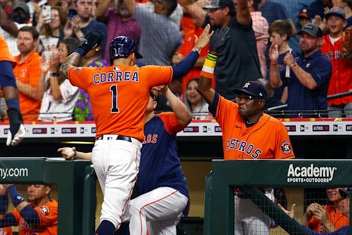 Dusty Baker high fives shortstop Carlos Correa